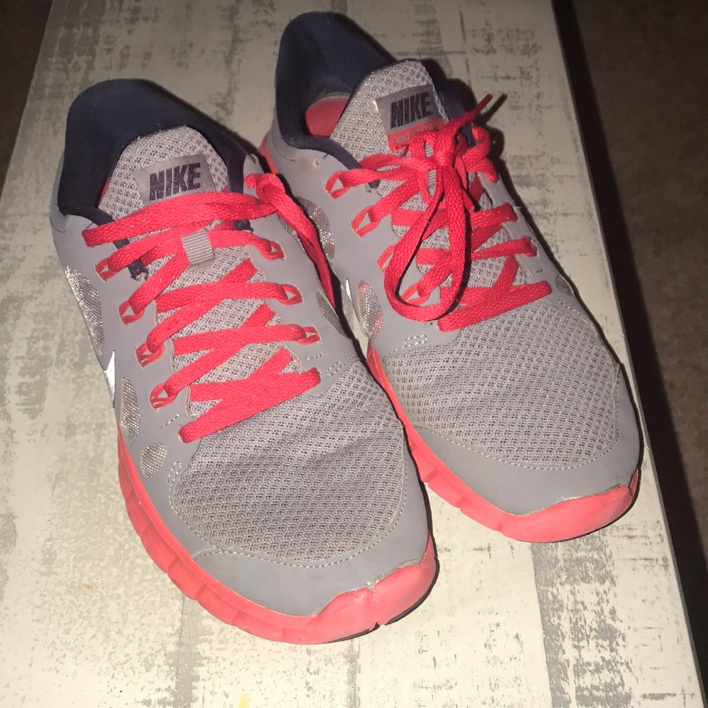 Grey and red Nike tennis shoes